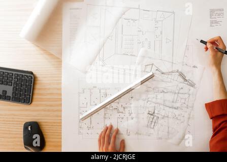 Top view of architect drawing and sketching on architectural project Stock Photo
