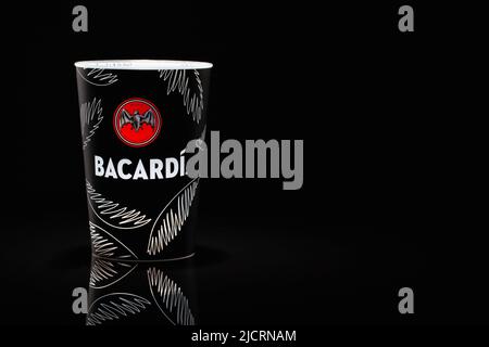 Prague, Czech Republic - 22, March 2022: Bacardi plastic cup for mixed drinks on the glass table. Stock Photo