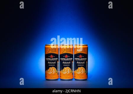 Prague, Czech Republic - 19, May 2022: Three cans San Pellegrino Orange fruit mineral waters on the blue background Stock Photo