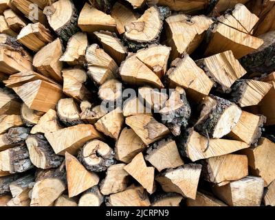 Background of a pile of chopped cherry trees lying on top of each other. Texture of chopped cherry trunks Stock Photo