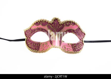 Carnival mask isolated on white background, Venetian theatre female face pink color, gold details ornate disguise, front view Stock Photo