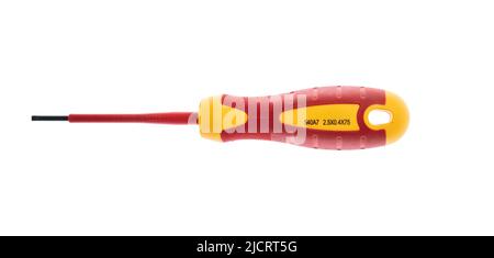 Screw drive tool isolated on white background. Screwdriver, new with rubber red and yellow handle, design element. Stock Photo