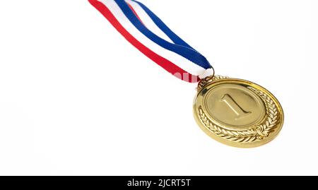 Gold medal, first place. Champion trophy award and red blue ribbon. Prize in sport for winner isolated cutout on white background, design element. Stock Photo