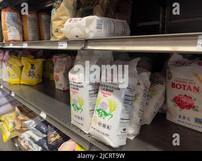 Mill Creek, WA USA - circa May 2022: Angled view of a variety of calrose rice bags for sale inside a Town and Country grocery store. Stock Photo