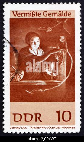 GDR - CIRCA 1967: a stamp printed in GDR shows Girl Gathering Grapes, Painting by Gerard Dou, circa 1967 Stock Photo