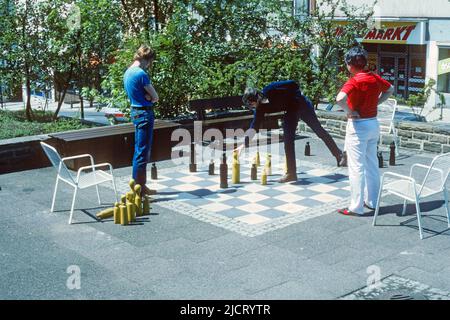 Men playing chess on a giant chessboard in the street in 1982, Siegen, North Rhine-Westphalia, Germany Stock Photo