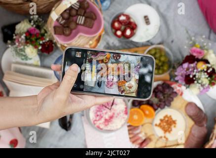 phone photographing charcuterie picnic food Stock Photo