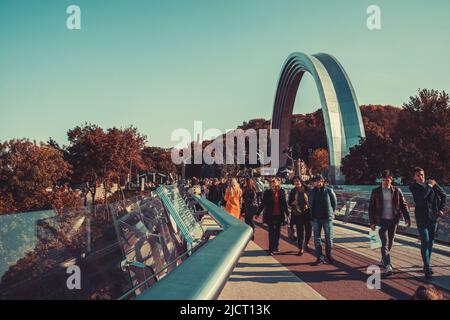 People walk on a glass bridge in Kyiv on an autumn day Stock Photo