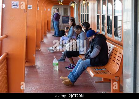 Passengers and commuters on Staten Island Ferry in New York City, United States of America Stock Photo