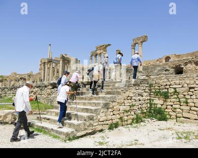 Tourists Entering Dougga Ruins to Explore Ancient Roman City Stock Photo