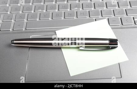 memo note and pen on laptops keyboard. High quality photo Stock Photo