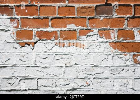 Grunge brick wall background with aging texture closeup. White and orange bricks Stock Photo