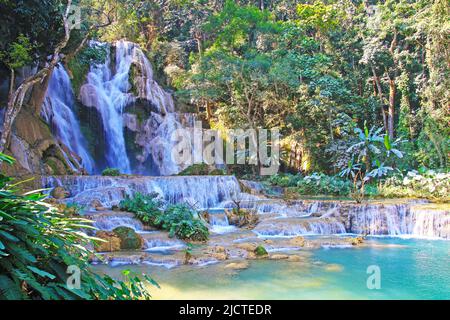 Beautiful secluded idyllic lonely wild jungle forest landscape lagoon, waterfall rock cascade, turquoise natural plunge pool - Kuang Si, Luang Prabang Stock Photo