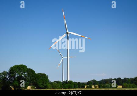 Wind turbines in a wind energy plant in a rural area in Germany. Sustainable and renewable energy source to replace coal, atom and other fossil fuels. Stock Photo