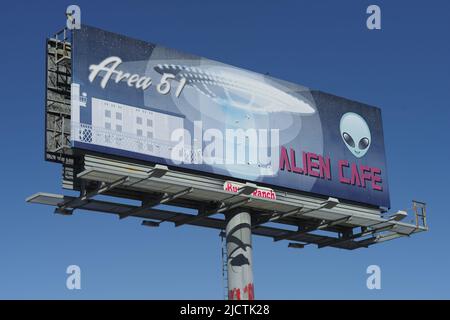 Amargosa Valley, Nevada: tall billboard indicating a cafe at Area 51 Alien Center shown on a sunny day with blue skies. Stock Photo