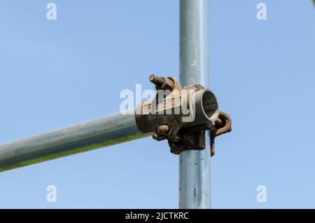 Scaffolding construction: detail with load-bearing structure in galvanized steel and joints joined by nuts and bolts. Stock Photo