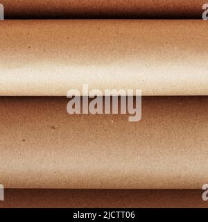 Sheets of craft paper rolled up close up. Natural background, copy space Stock Photo
