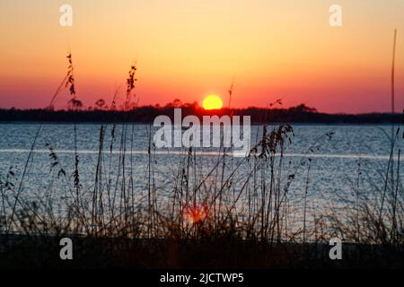 sunset over Amelia River, nature, sky, water, tall grass, Little Tiger Island beyond,  from Fort Clinch State Park, Amelia Island, Fernandina Beach; F Stock Photo