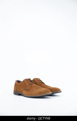 Pair of male camel suede classic shoes isolated on the white background. Stock Photo
