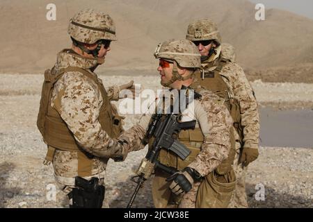 U.S. Marine Corps Sgt. Maj. Michael F. Jones (left), Sgt. Maj. of 2D Marine Expeditionary Forces, shakes the hand of Lt. Col. Kevin C. Trimble, Battal