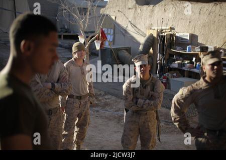 U.S. Marines with Weapons Company, 1st Battalion, 8th Marine Regiment (1/8), Regimental Combat Team 6, receive a debrief from Squad Leader Sgt. Hiram Stock Photo