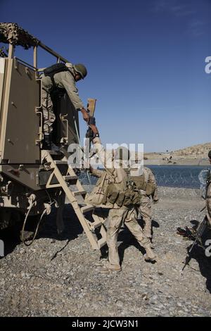 Afghan Task Force (ATF) soldiers offload from a Medium Tactical Vehicle Replacement across the Helmond River from patrol base (PB) Manassas in Kajaki, Stock Photo