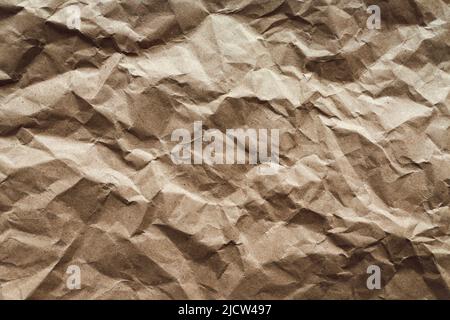 Crumpled paper texture, brown recycled paper abstract background Stock Photo