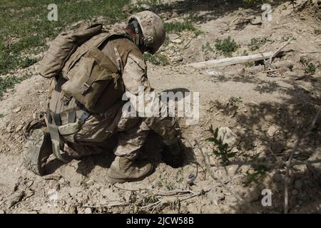 U.S. Marine Corps Lance Cpl. Jason Kelleher with 1st Combat Engineer Battalion, 1st Marine Expeditionary Forces Forward, places a drop charge into an