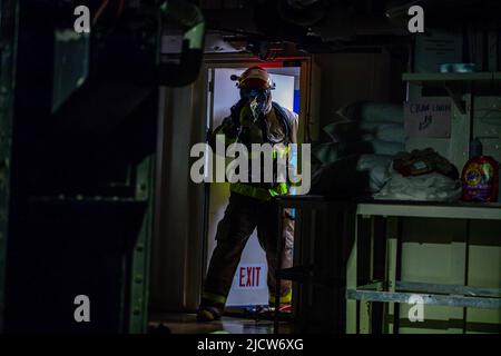 220615-N-EI510-0185 BALTIC SEA (June 15, 2022) Retail Services Specialist 3rd Class Dennis Parker responds to a simulated fire during firefighting training aboard the Blue Ridge-class command and control ship USS Mount Whitney (LCC 20) in the Baltic Sea, June 15, 2022, during exercise BALTOPS22. BALTOPS22 is the premier maritime-focused exercise in the Baltic Region. The exercise, led by U.S. Naval Forces Europe-Africa, and executed by Naval Striking and Support Forces NATO, provides a unique training opportunity to strengthen combined response capabilities critical to preserving freedom of na Stock Photo