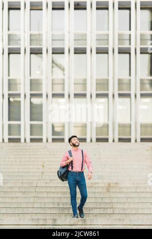 Asian man walking down a stairs in the city Stock Photo