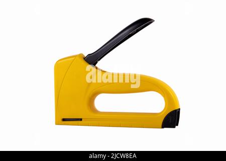 Yellow staple gun isolated on white background. Stock Photo