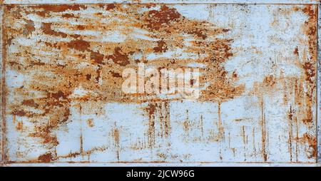 Rusty sheet of painted metal with peeling paint. The background is framed in a metal frame. Stock Photo