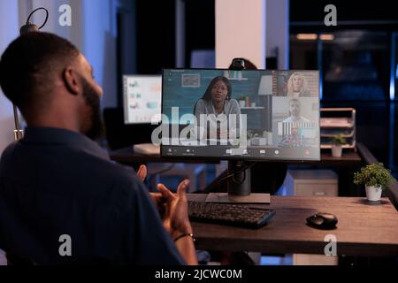 Businessman using remote teleconference call in online meeting with colleagues, videocall conversation with webcam on computer. Talking about project research on internet videoconference chat. Stock Photo