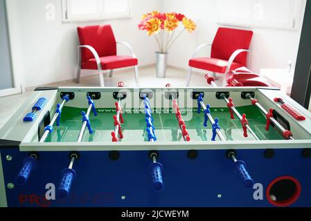 Close up of foosball Table Soccer Game match figures. Football Kicker Game with blue and red figurines. Stock Photo