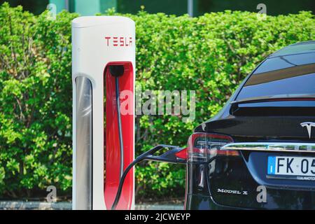 Tesla charging station to welcome electric car owners. Turin, Italy - June 2022 Stock Photo