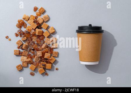 Cup of coffee with brown sugar on gray background Stock Photo