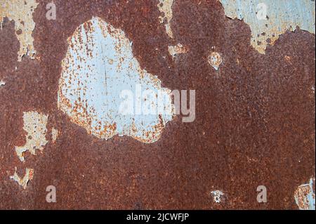 Rusty surface with old paint residue. Rusty metal surface as background image. Metal surfaces covered with rust Stock Photo