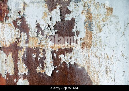 Rusty surface with old paint residue. Rusty metal surface as background image. Metal surfaces covered with rust Stock Photo