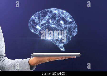 Artificial intelligence and machine learning concept with digital glowing human brain symbol above digital tablet on woman palm on dark background Stock Photo