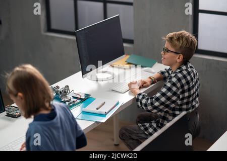 School kids using computer in classroom at school Stock Photo