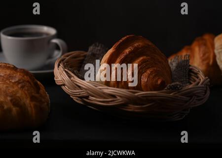 Homemade butter croissants in wicker basket ready to serve for breakfast. Breakfast, bread bakery products cafe concept Stock Photo
