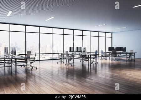 Perspective view on comfortable workspaces with modern computers in minimalistic interior design coworking office with wooden parquet and huge window Stock Photo