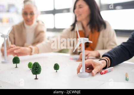 Group of senior students discussing altenrative energy with teacher in classroom, close-up. Stock Photo