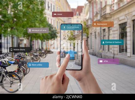 Tourist information and signposts on smart phone in tourist hands. The concept of using augmented reality apps and technology in tourism Stock Photo