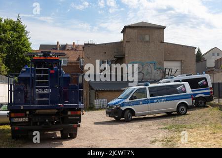 Gotha, Germany. 16th June, 2022. Police cars drive off a factory site after a raid. With a large contingent, police searched a total of 26 residential and business premises in Thuringia, Schleswig-Holstein and Berlin on Thursday. According to the Thuringian State Criminal Police Office (TLKA), more than 500 officers from Thuringia as well as special forces from other federal states were deployed. Suspicion exists because of the trade with narcotics in connection with money laundering as well as offence against the weapon law. Credit: Michael Reichel/dpa-Zentralbild/dpa/Alamy Live News
