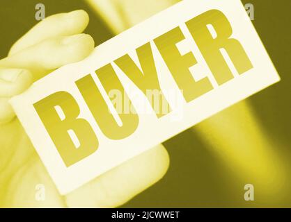 Buyer word on the card shown by a man. Customer business concept. Stock Photo