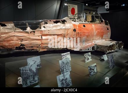 The wreckage of a WW2 Mitsubishi Zero A6M war plane on display at the Imperial War Museum (IWM) in London. The wreckage was found in the Marshall Isla Stock Photo