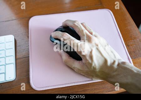 Using wireless computer mouse on a mouse pad Stock Photo