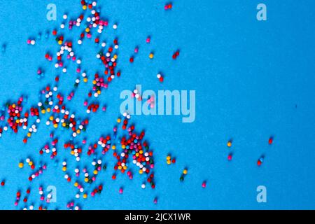 Sugar baking colorful sprinkles in shape of circle isolated on a blue background. Holiday concept Stock Photo