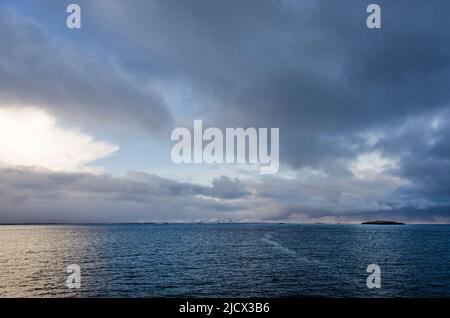 View from the deck of a ferryboat across Breiðafjörður in Iceland under a sky with spectacular clouds Stock Photo